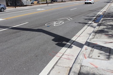 a shared roadway where a sharrow marking is added to the rightmost lane.