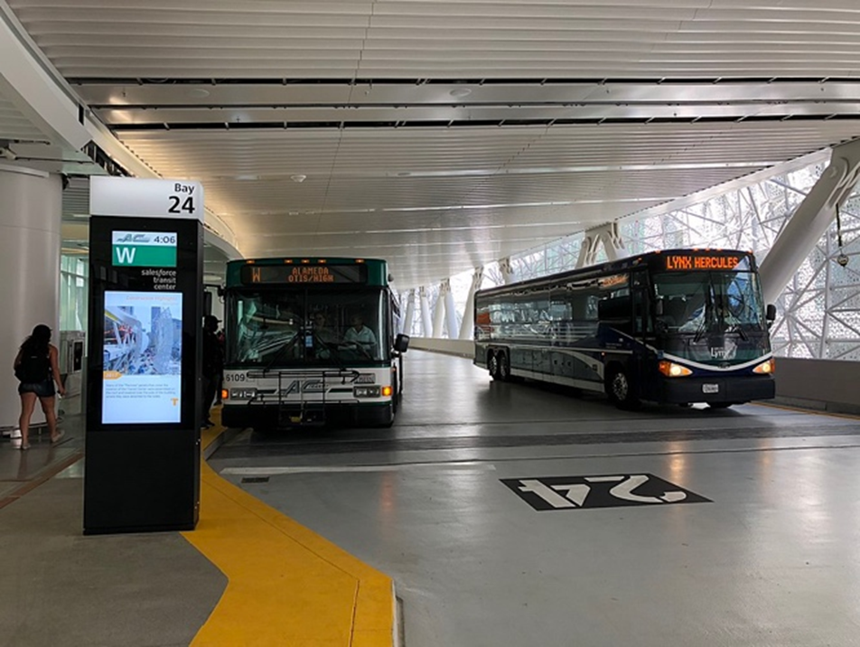 Image shows two busses side by side inside the Salesforce Transit Center.