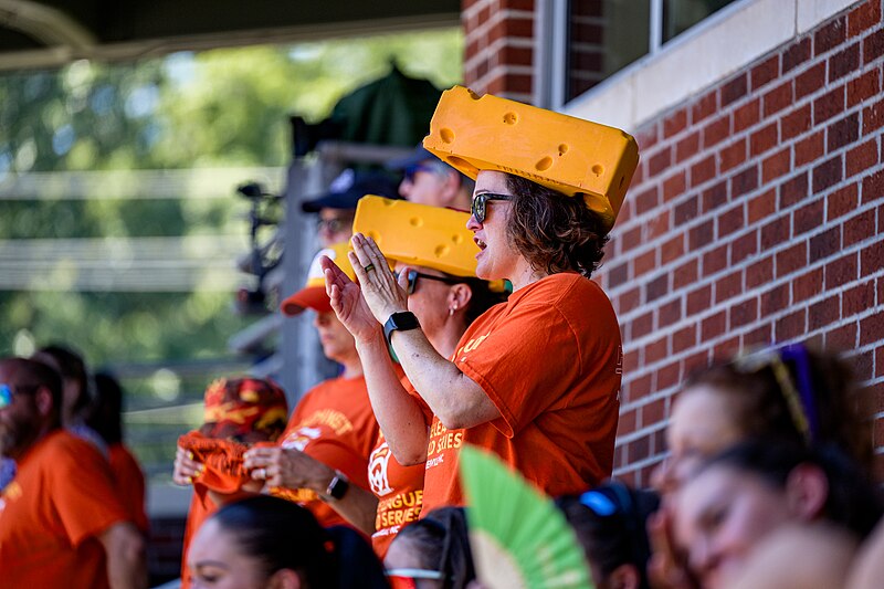 People wearing foam hats that look like cheese