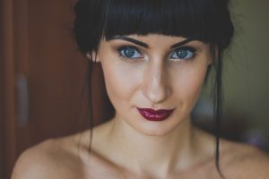A tall woman with brown hair and blue eyes