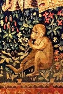 A woven monkey in a tapestry eats fruit