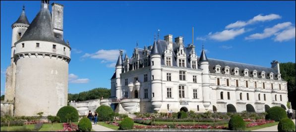 A white Renaissance castle with a medieval tower