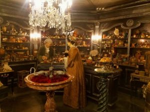 A woman shops in an ornate 18th Century perfume shop