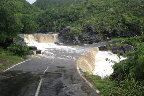 Water floods across a road