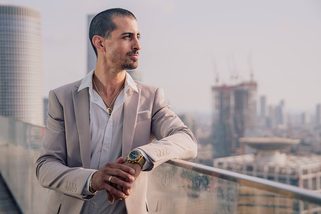 young man with mustache and short beard standing on balcony