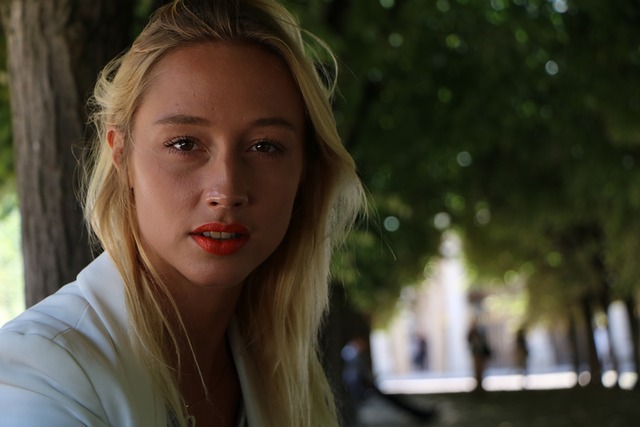 Young woman with blonde hair in a park