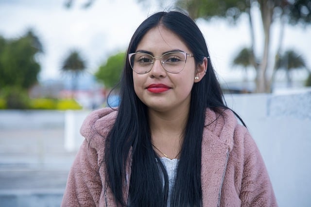 young woman with black hair and glasses