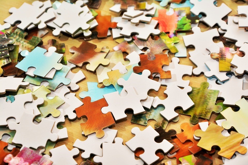 puzzle pieces on a table, unassembled